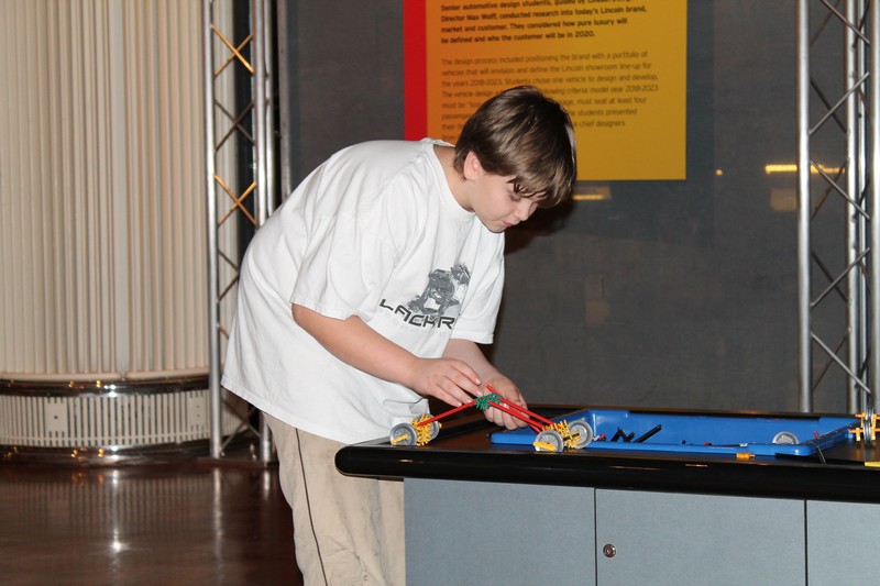 Jacob lining his lego car up to race.
