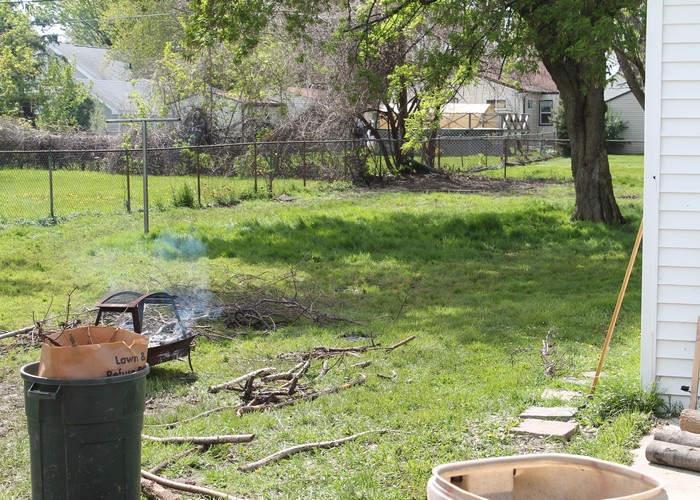 The prior owners had a huge pile of branches in the back of the yard. Here we are burning what we can and bagging up the rest.