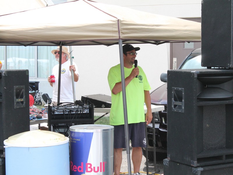 Joe walked around the parking lot talking to people on the microphone.