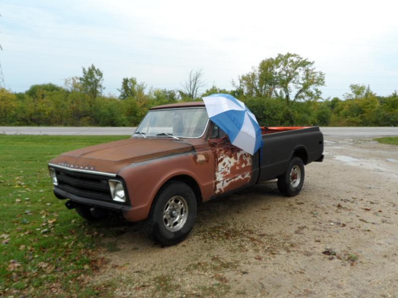 My old ratty 68 pickup.The day this was taken it had started to rain,my daughter went to roll up the window and broke the regulator,this was her solution.gotta love it