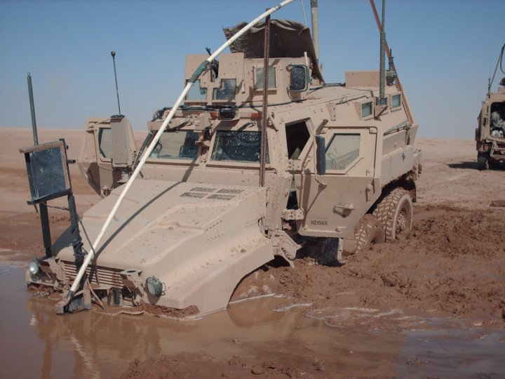 A lil stuck. This is the day we found out 4 times that 40 tons WILL NOT float on water. Keep in mind that the top of the wheel well is 5 feet from the ground